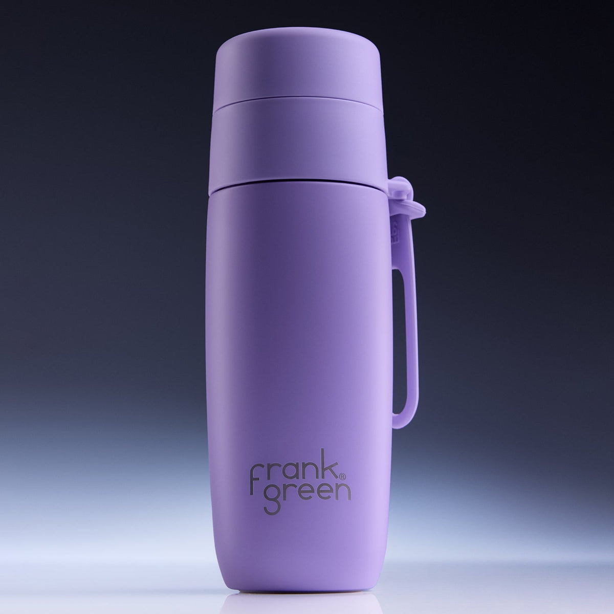 A matte purple vacuum-insulated water bottle with a matching carrying loop and lid, featuring the 'frank green' logo printed on the front, set against a dark gradient studio background.