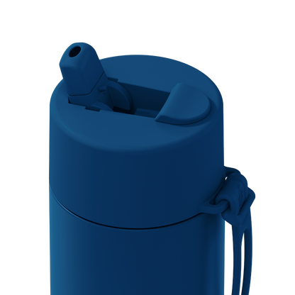 Close-up of a matte dark blue insulated bottle with a flip-top lid and carrying loop on a solid white background.