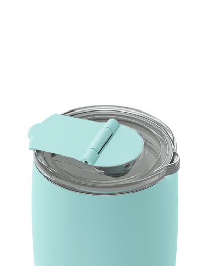 A close-up of a matte mint green insulated tumbler with a clear lid and matching mint green flip-up straw cover, shown on a white background.
