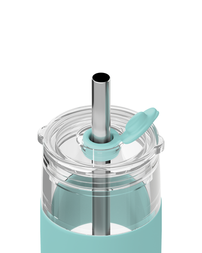Close-up of a clear travel tumbler with a mint green silicone sleeve, clear lid, stainless steel straw, and matching mint green flip straw cap on a white background.