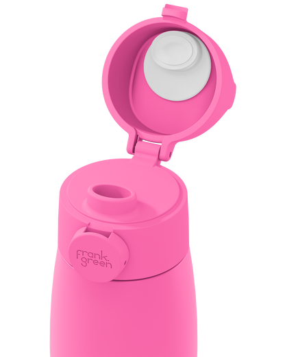 Close-up of a bright pink grip handle lid flipped open on the matching bottle, showing the white inner seal, drinking spout, and circular 'frank green' logo tab on a plain white background.