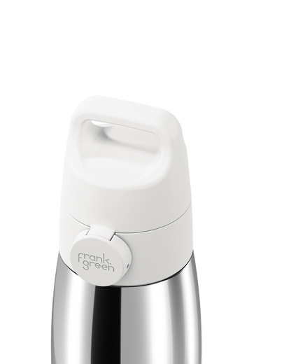 Close-up of a white grip handle lid with a built-in carry handle and a circular 'frank green' logo tab, closed on a polished stainless steel bottle against a plain white background.