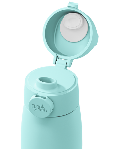 Close-up of a mint green grip handle lid flipped open on the matching bottle, showing the white inner seal, drinking spout, and circular 'frank green' logo tab on a plain white background.