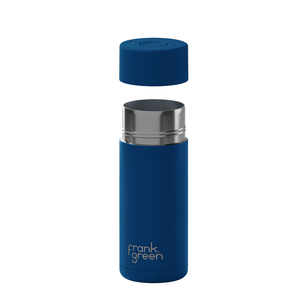 A blue vacuum-insulated travel tumbler with a matching blue cap floating above the open top, featuring a silver stainless steel rim and the 'frank green' logo near the bottom, shown on a plain white background.