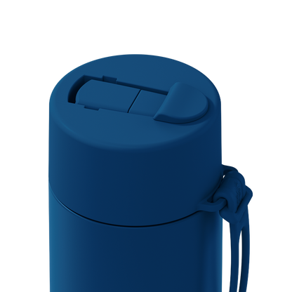 Close-up of a matte dark blue insulated tumbler with a flip-top lid and attached wrist strap on a plain white background.