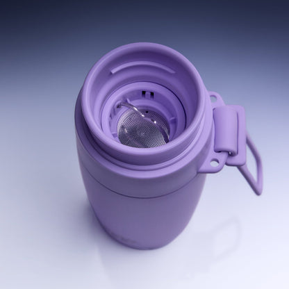 A lavender purple vacuum-insulated travel tumbler with its lid off, showing a stainless steel mesh tea infuser inside and a matching plastic carrying loop on the side, set against a clean studio gradient background.