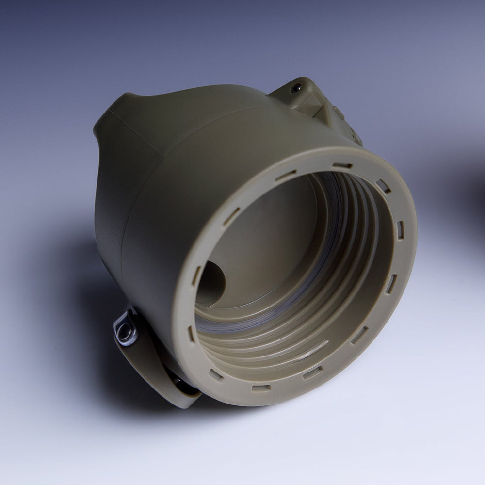 A single molded plastic cylindrical component with a threaded interior and a small attached strap, photographed on a clean studio background. No person, animal, or real environment is present, so this is Product/Packaging.